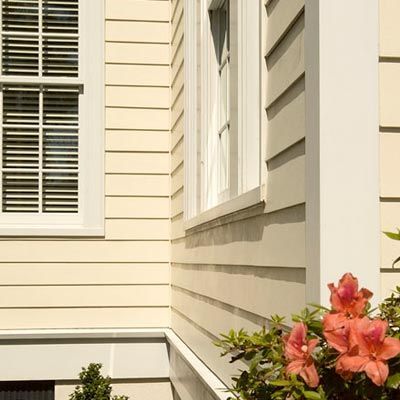 A house with a window and flowers on the side