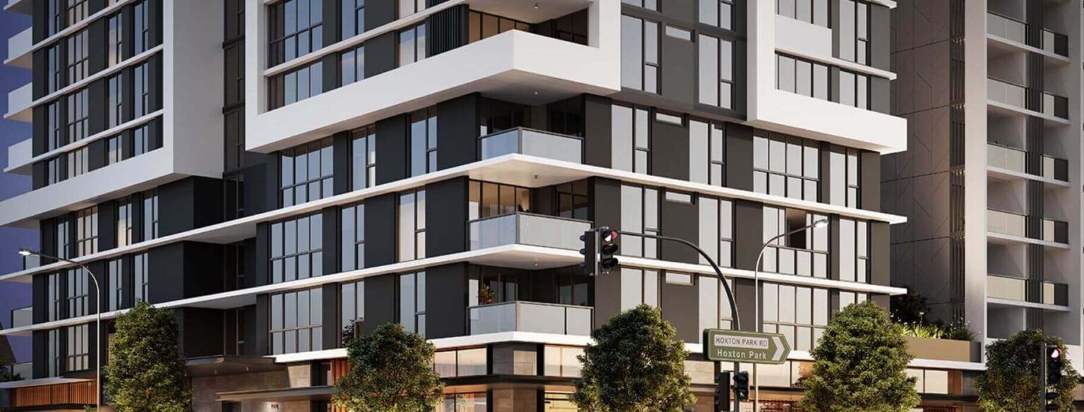 Modern high-rise building with glass windows, white accents, and street-level shops.