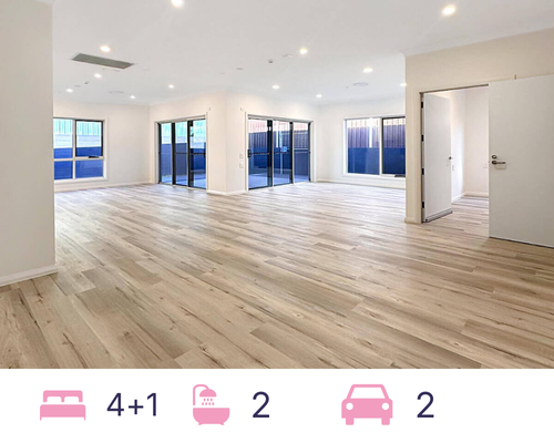 Located in the charming Hamlet Crescent, this modern kitchen features light wood flooring, white cabinets, and a central island. It's well-lit with ceiling lights and boasts three large windows. For safety, a fire extinguisher is mounted on the wall. Experience contemporary living in Rosemeadow, NSW 2560.