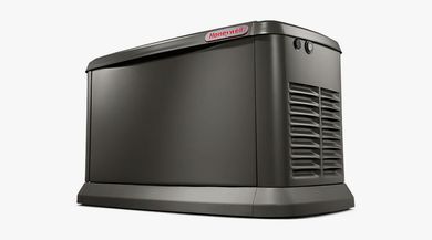 A black generator is sitting on top of a white surface.