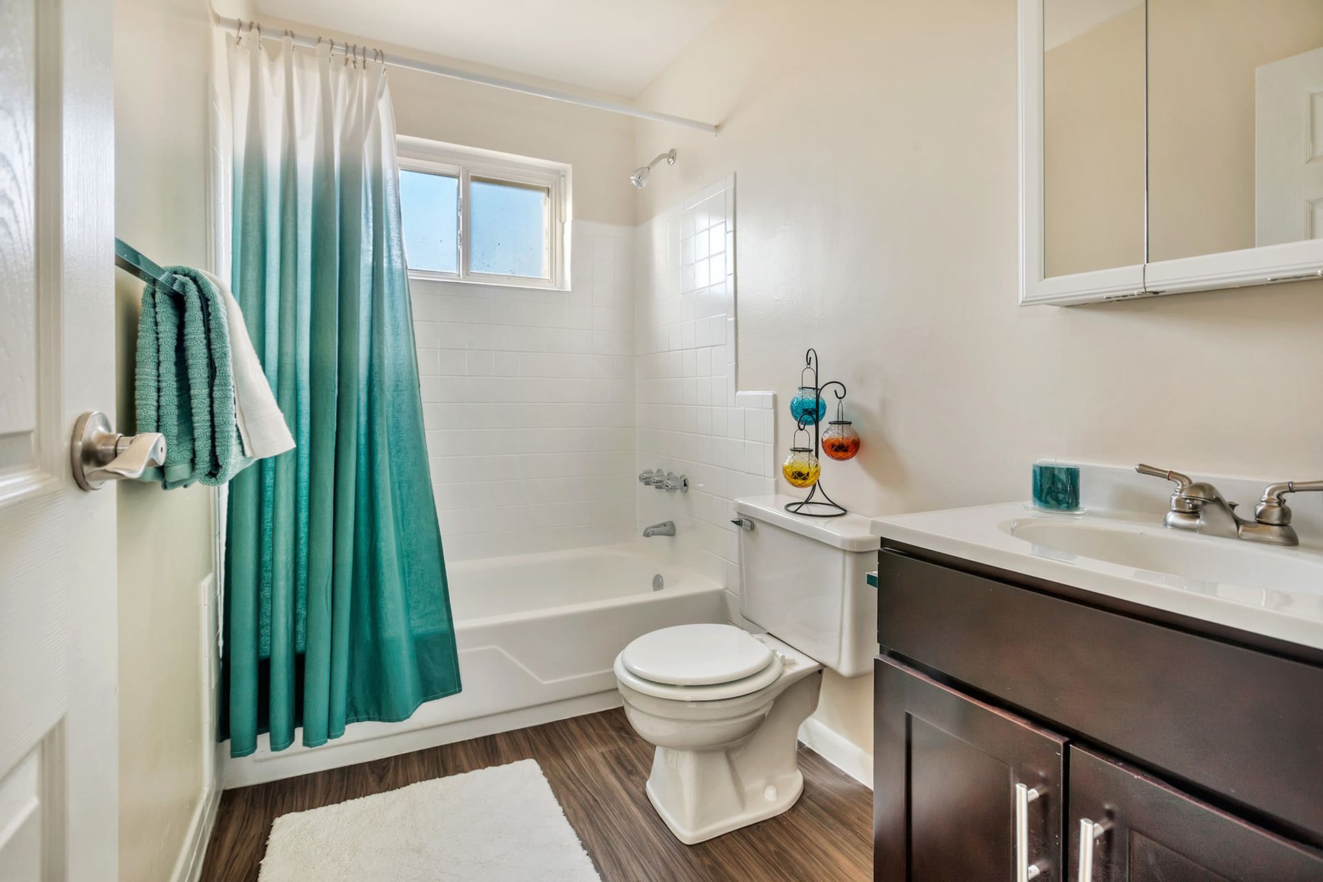 Bathroom featuring a tub/shower, toilet, and vanity.