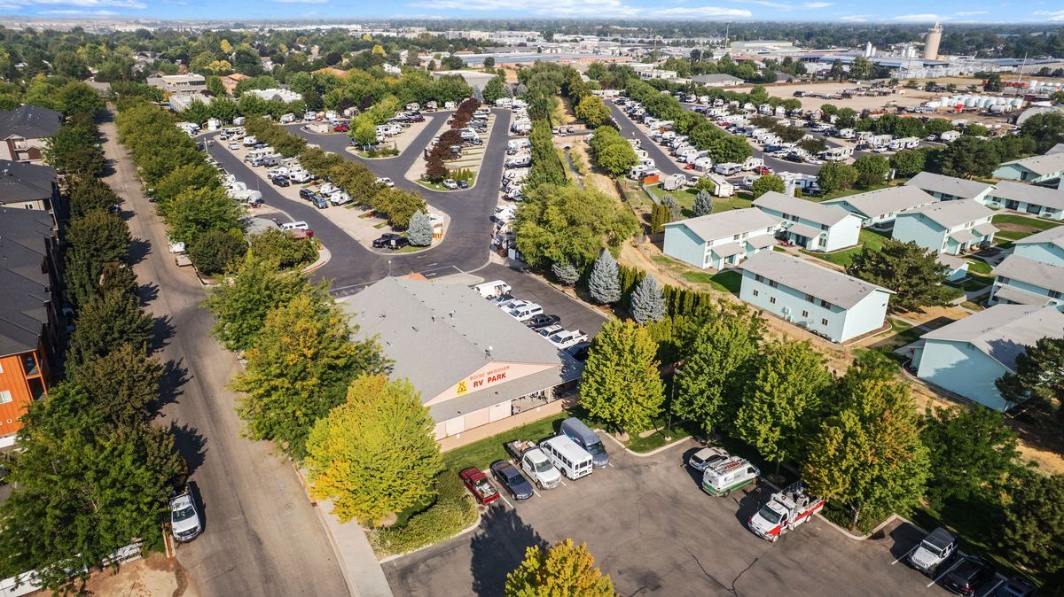 Aerial view of the Boise Meridian KOA with  tree-lined streets and parked RVs.