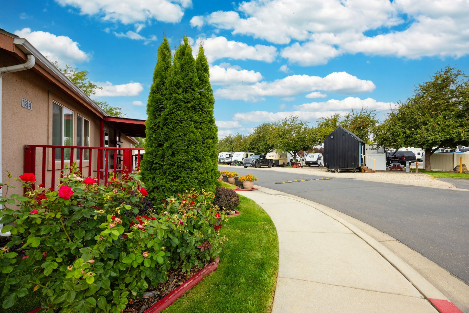 The Boise Meridian KOA displays colorful flowers under a bright blue sky.