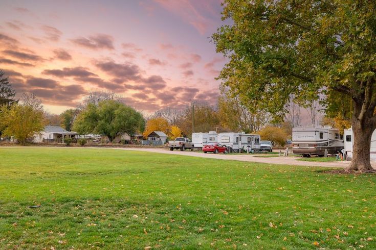 Mason Creek RV Park at sunset with trees and several parked RVs along a roadside.