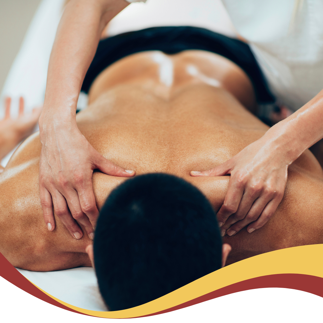 A man is laying on a bed getting a massage