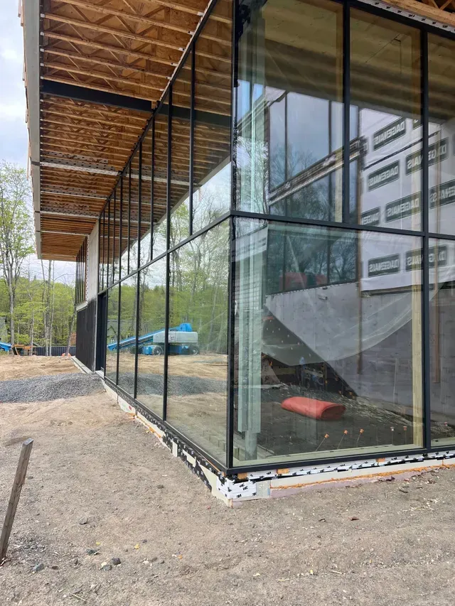 A large building with a lot of windows is being built.