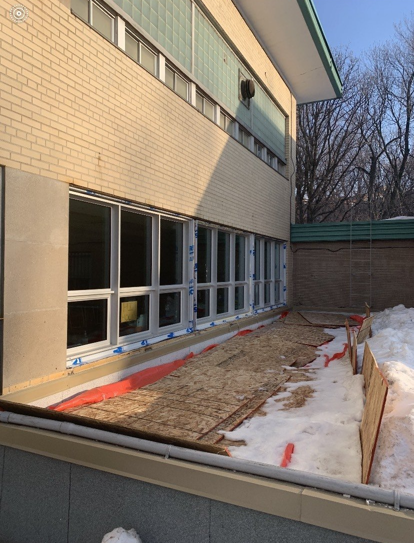 A building with a lot of windows is being remodeled