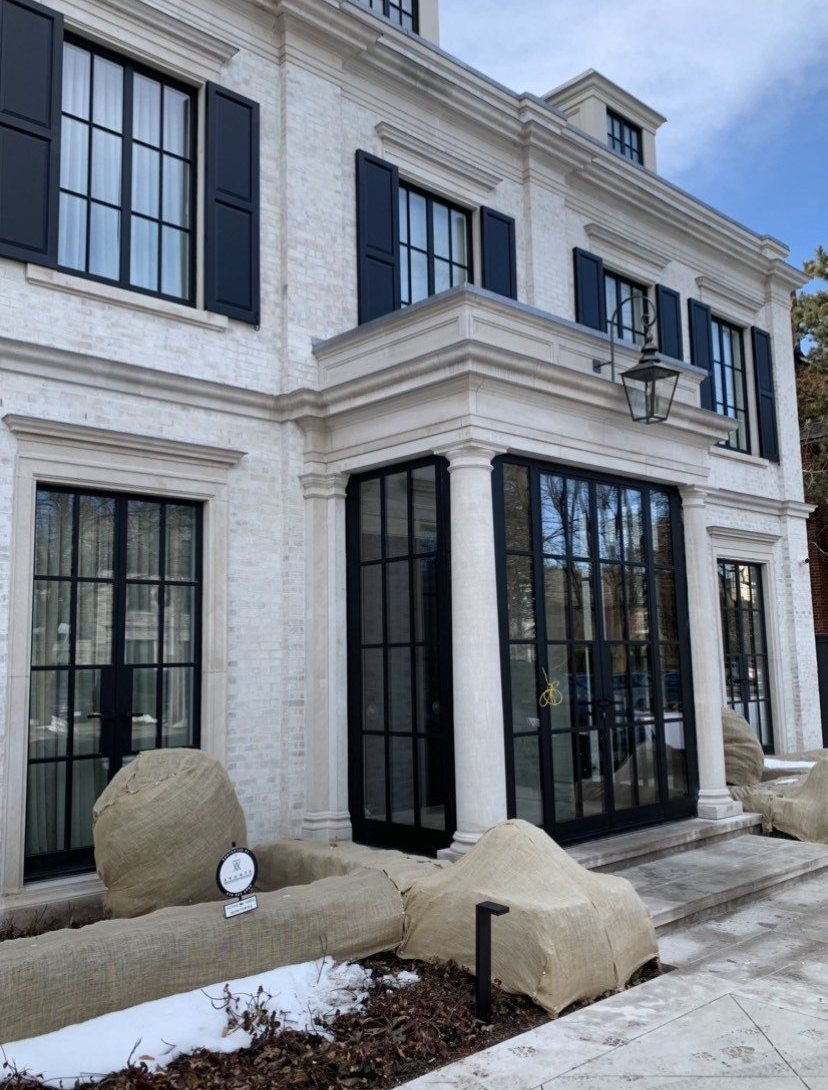 A large white house with black shutters on the windows