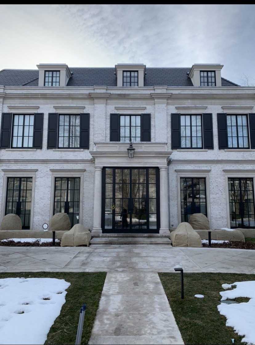 A large white house with black shutters on the windows