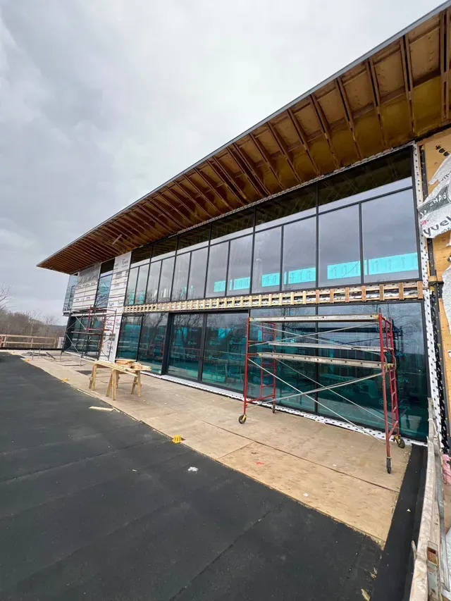 Un grand bâtiment avec beaucoup de fenêtres est en construction.