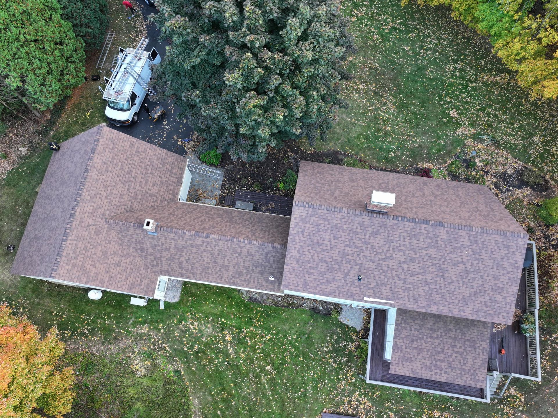 An aerial view of a house with a truck parked in front of it.