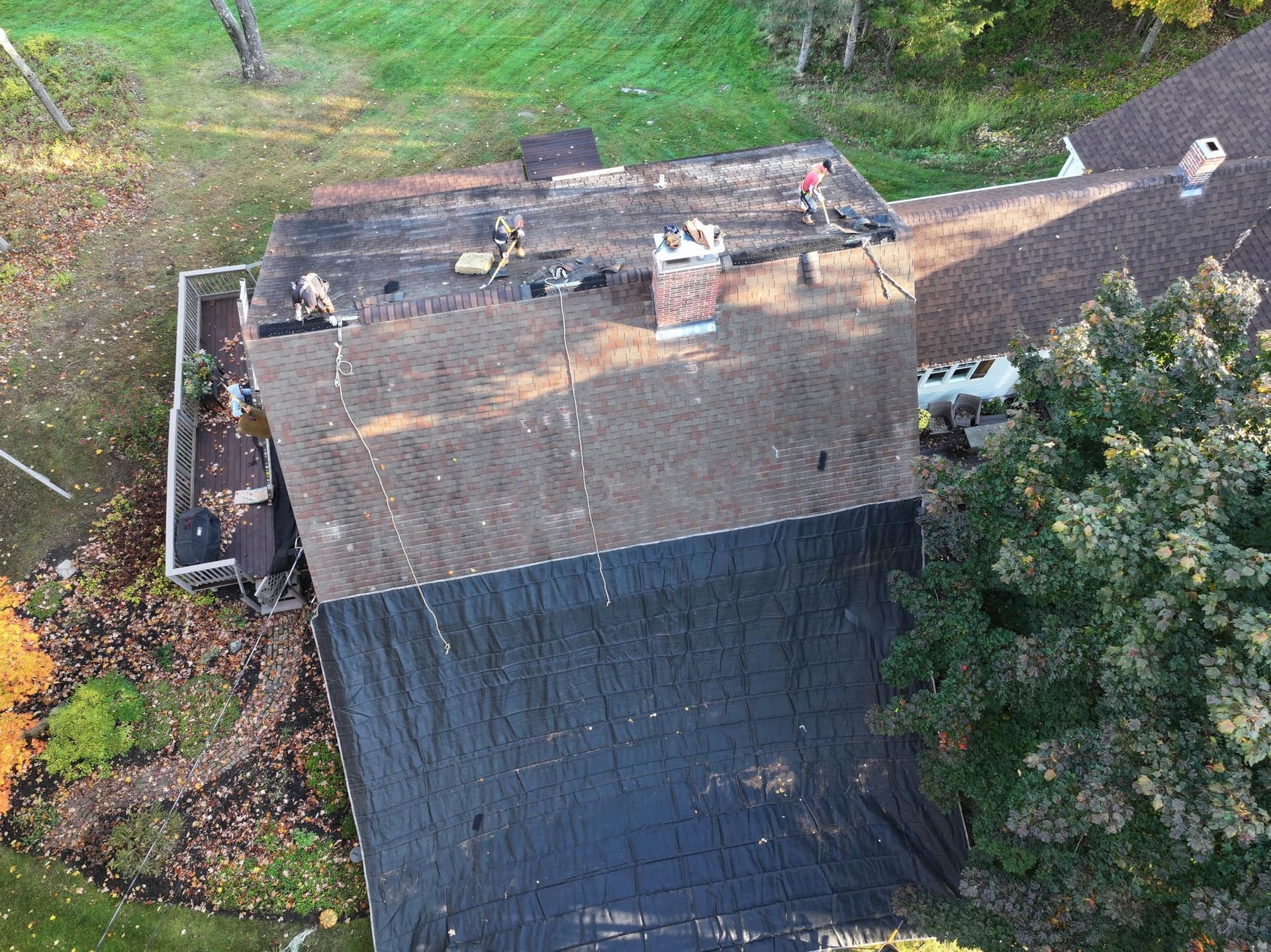 An aerial view of a house with a roof that is being repaired.