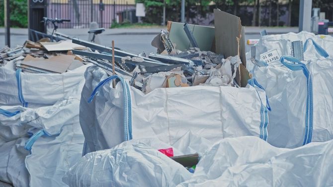 Damaged tarped debris and rubble piled outdoors after construction or demolition