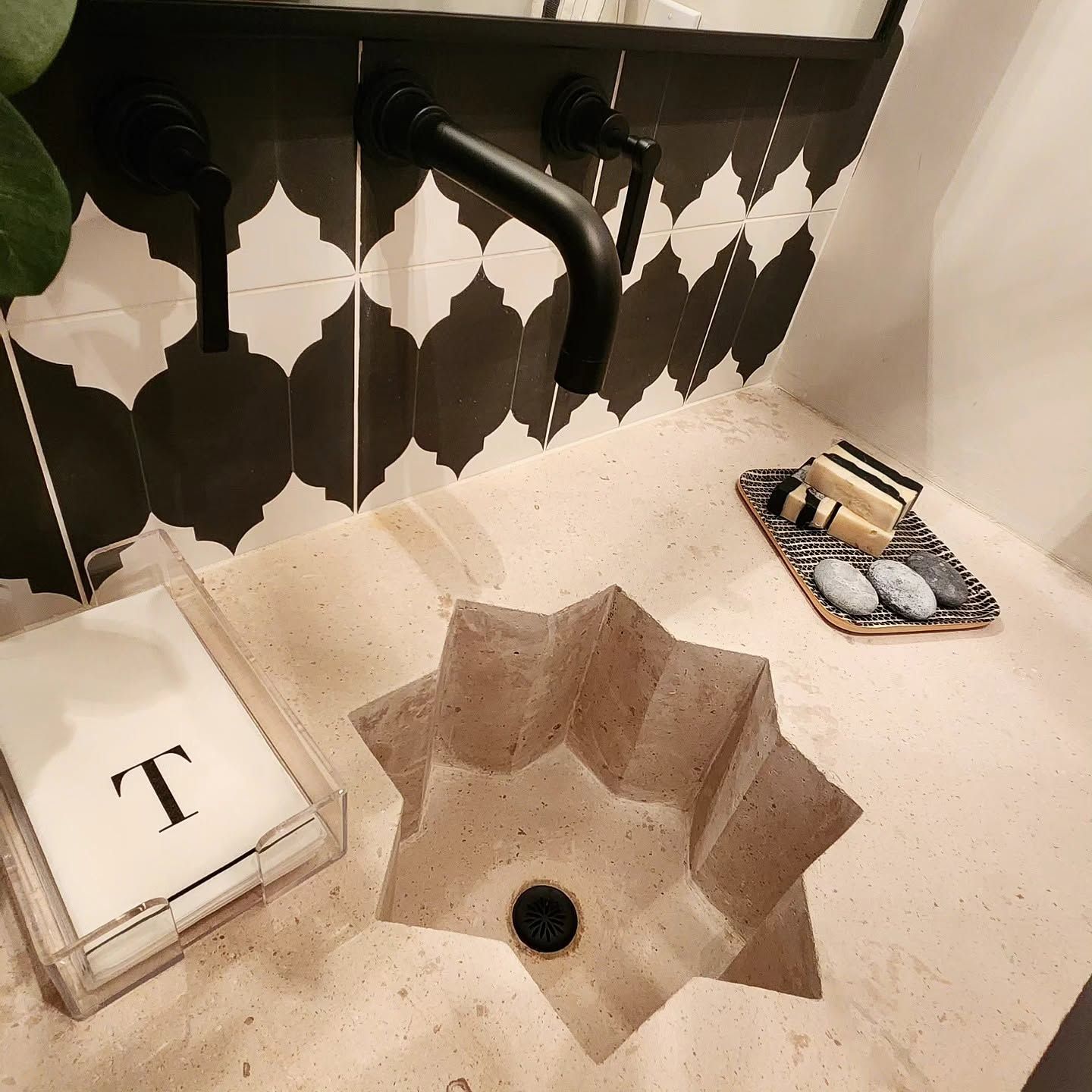 Office meeting with two people discussing a presentation at a whiteboard and laptop