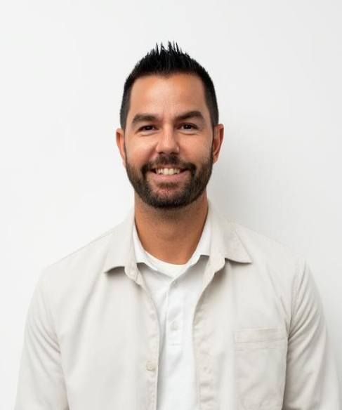 Smiling man in a gray striped polo shirt against a white background