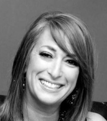 Black-and-white headshot of a smiling woman with shoulder-length hair
