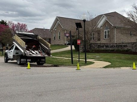 A dump truck unloading materials at the entrance of