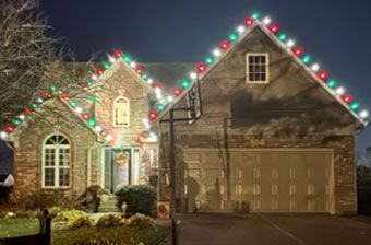 House decorated with Christmas lights, featuring red, green, and white bulbs. House decorated with Christmas lights, featuring red, green, and white bulbs.