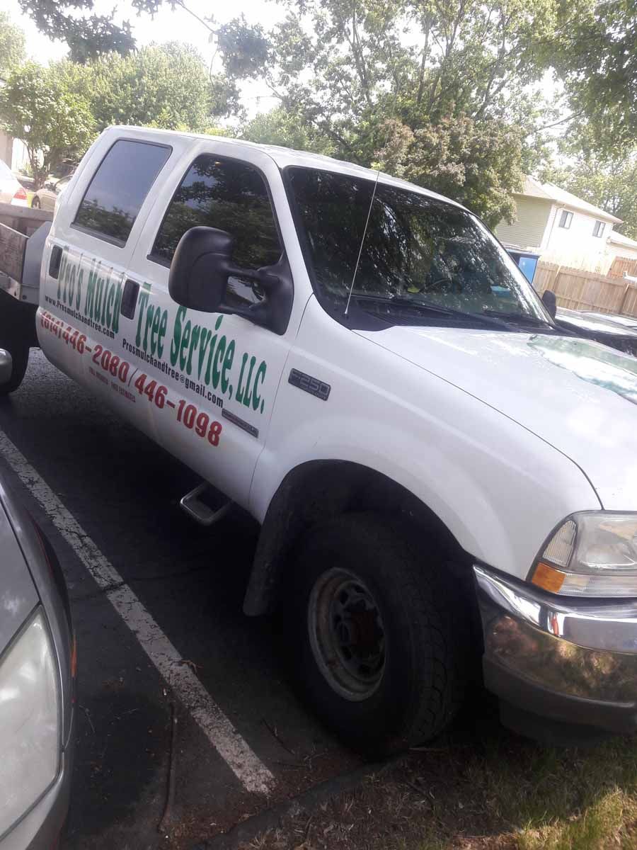 A white truck is parked in a parking lot