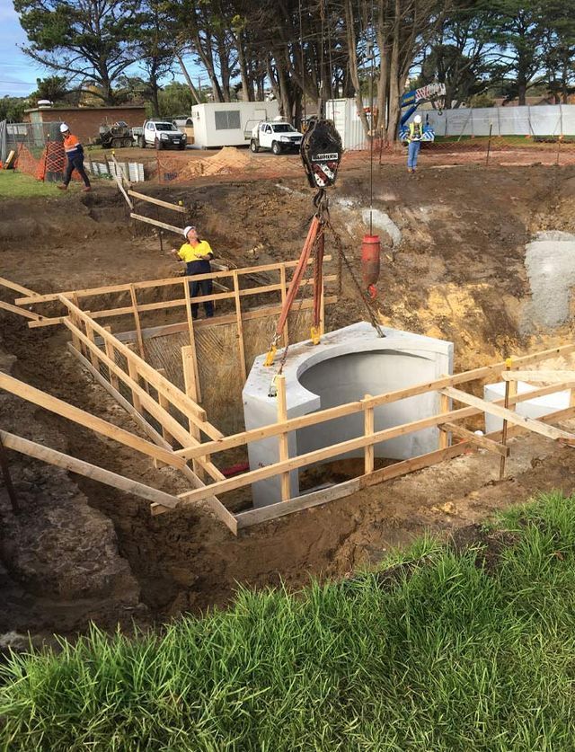 A Crane Is Lifting A Large Concrete Block Into A Hole – Warrnambool, VIC - McKinnon Quarries & Civil