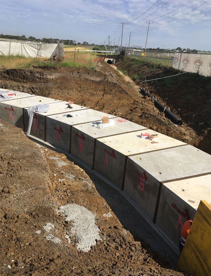 A Row Of Concrete Blocks Are Sitting On Top Of A Dirt Field – Warrnambool, VIC - McKinnon Quarries & Civil
