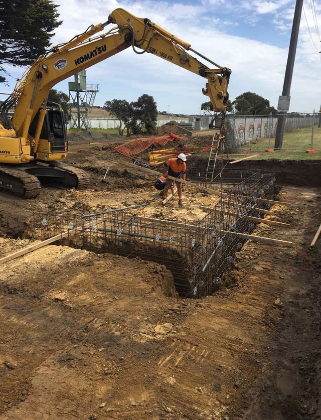 A Yellow Excavator Is Digging A Hole In The Ground – Warrnambool, VIC - McKinnon Quarries & Civil