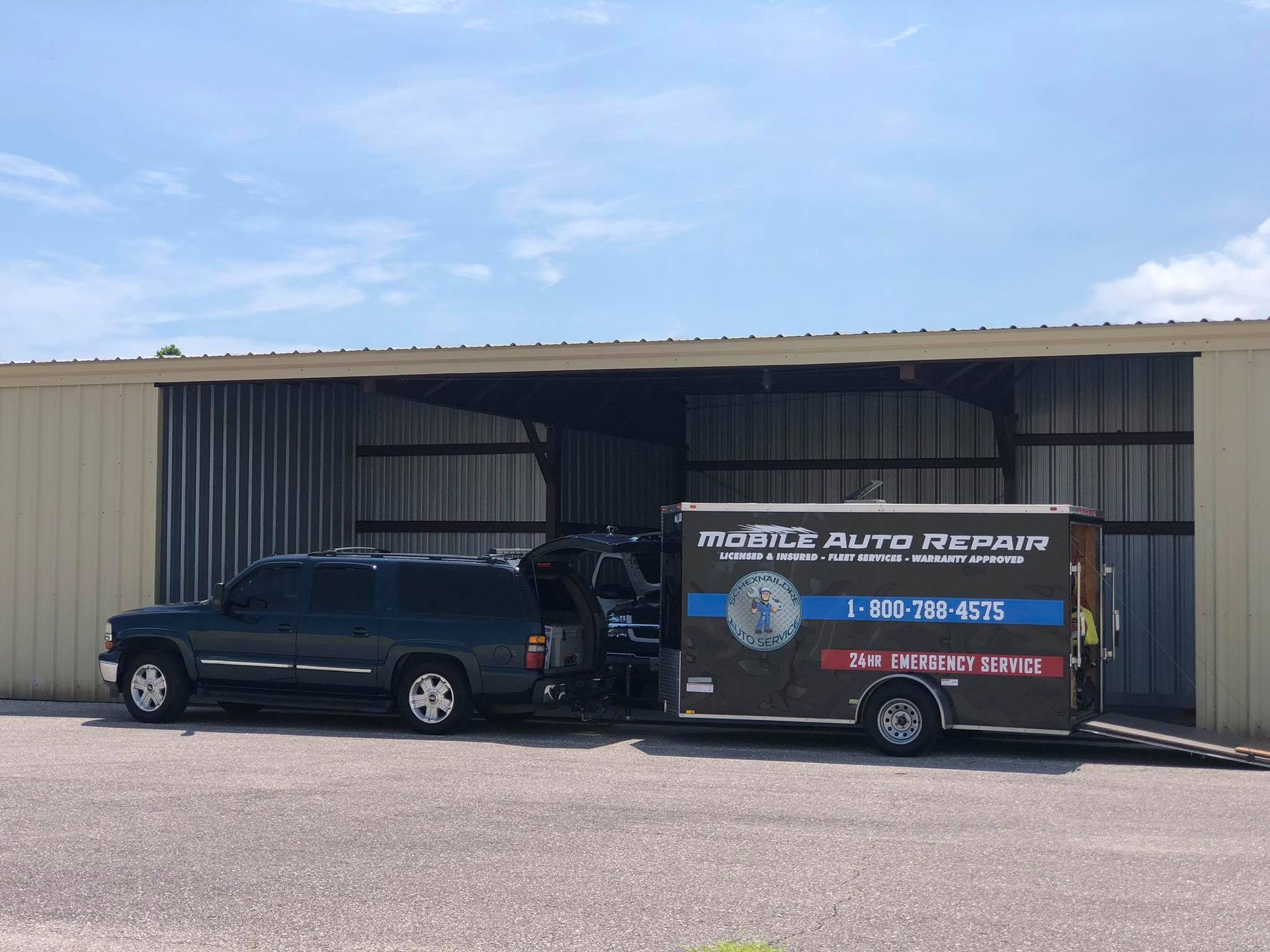 Dark SUV and trailer, both branded