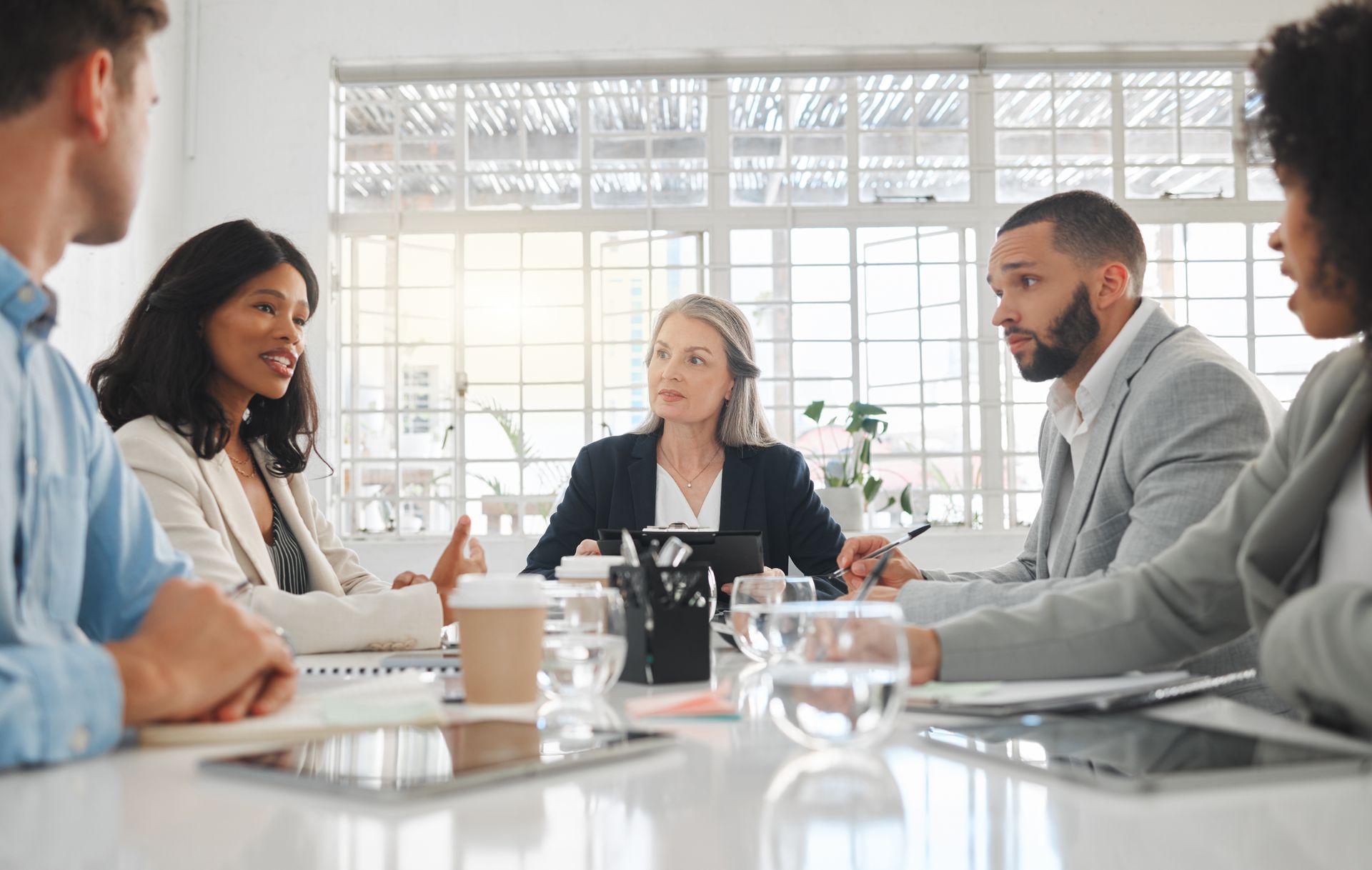 A group of people are sitting around a table having a meeting.