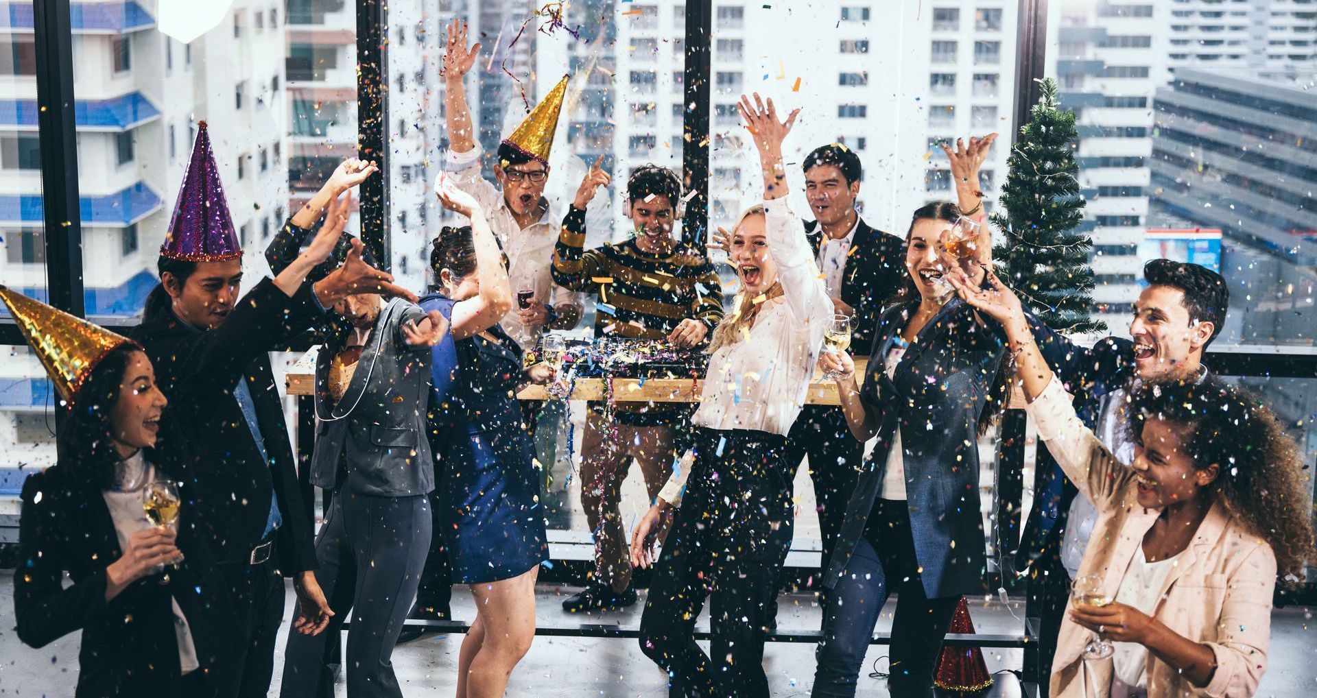 A group of people are celebrating in an office.
