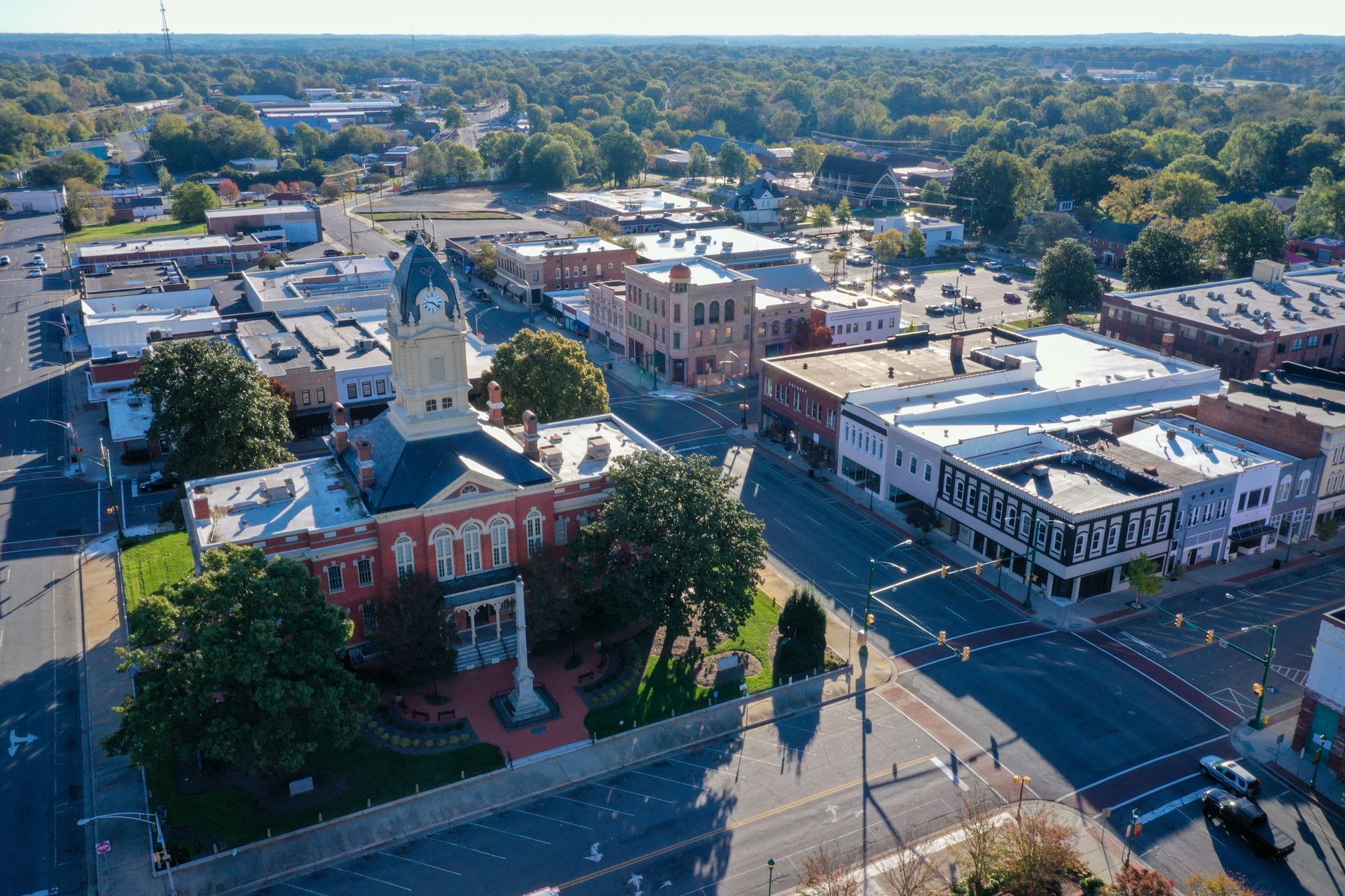 An aerial view of a small town with a courthouse in the middle.