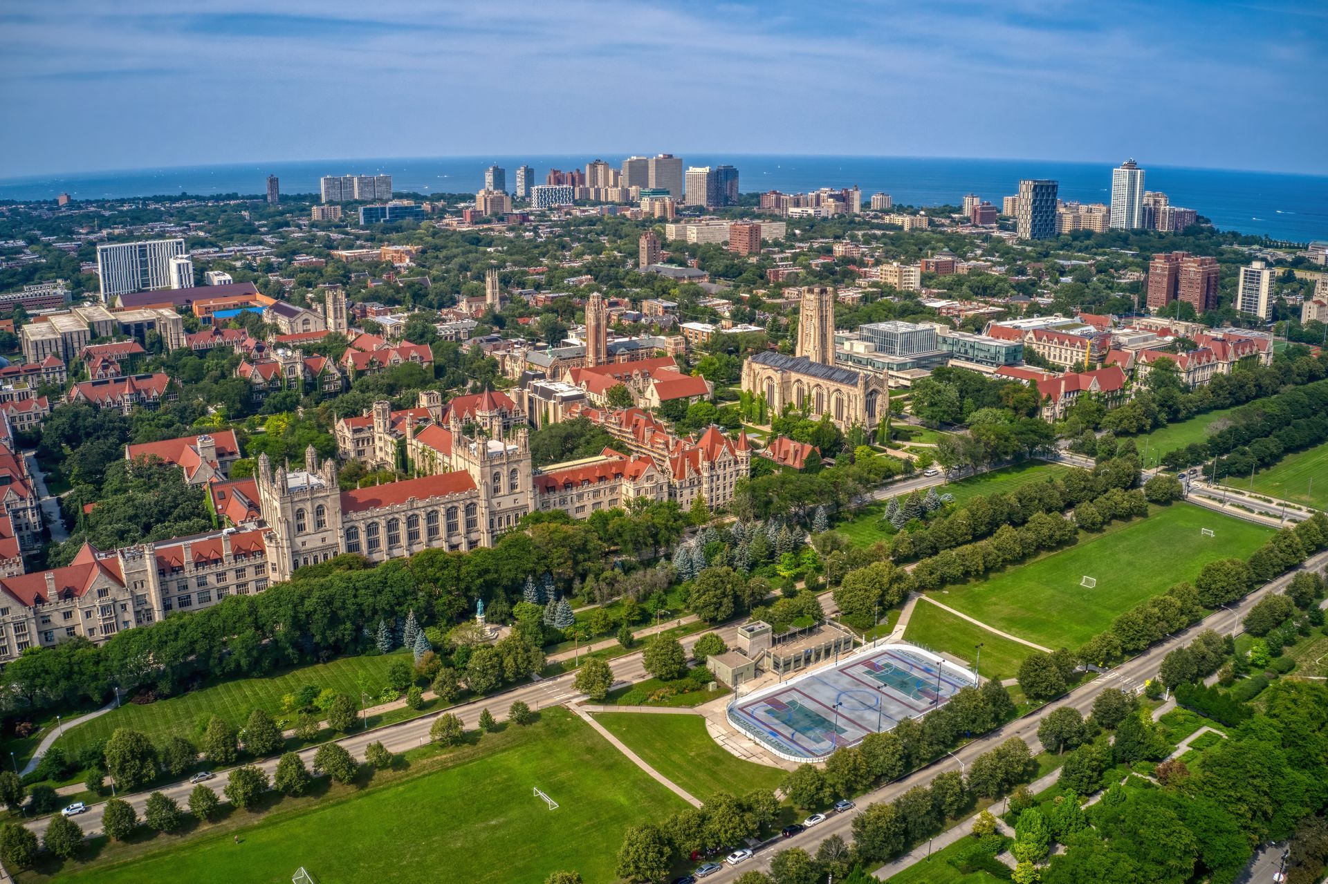 An aerial view of a city with a tennis court in the middle of it.