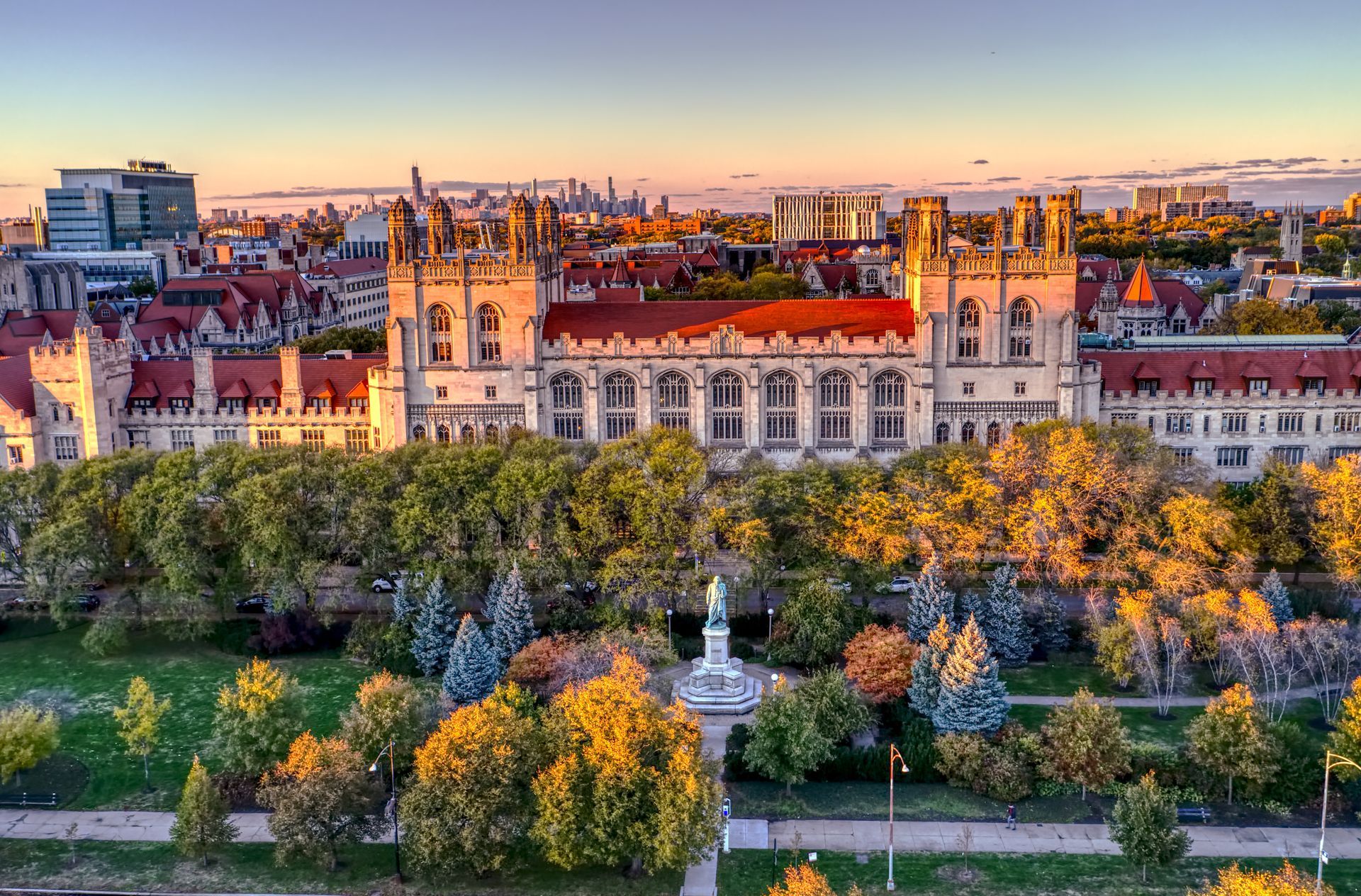 An aerial view of a large building surrounded by trees and a park.