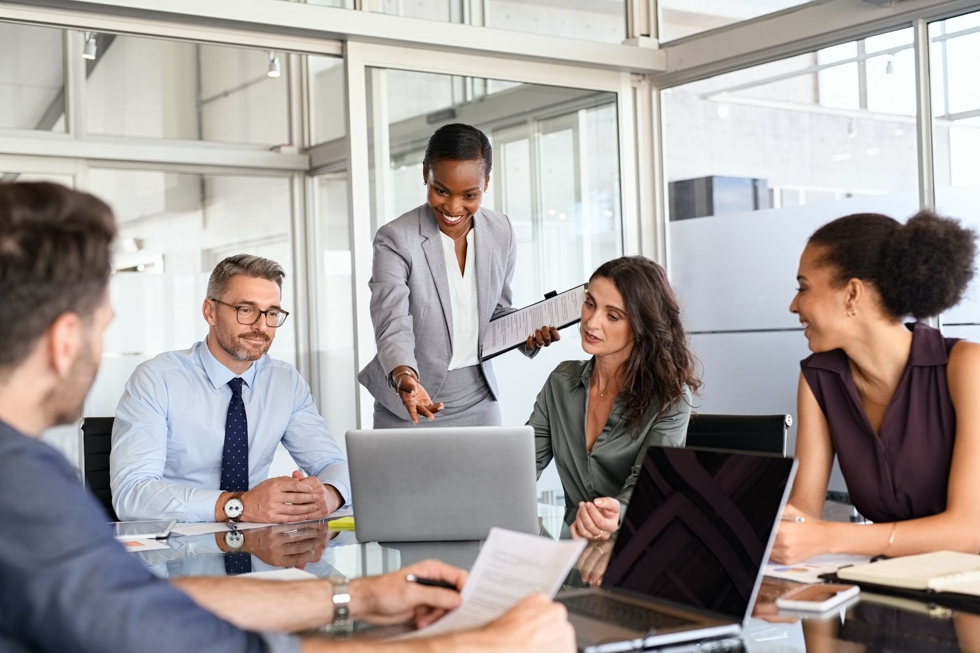 A group of business people are having a meeting in a conference room.