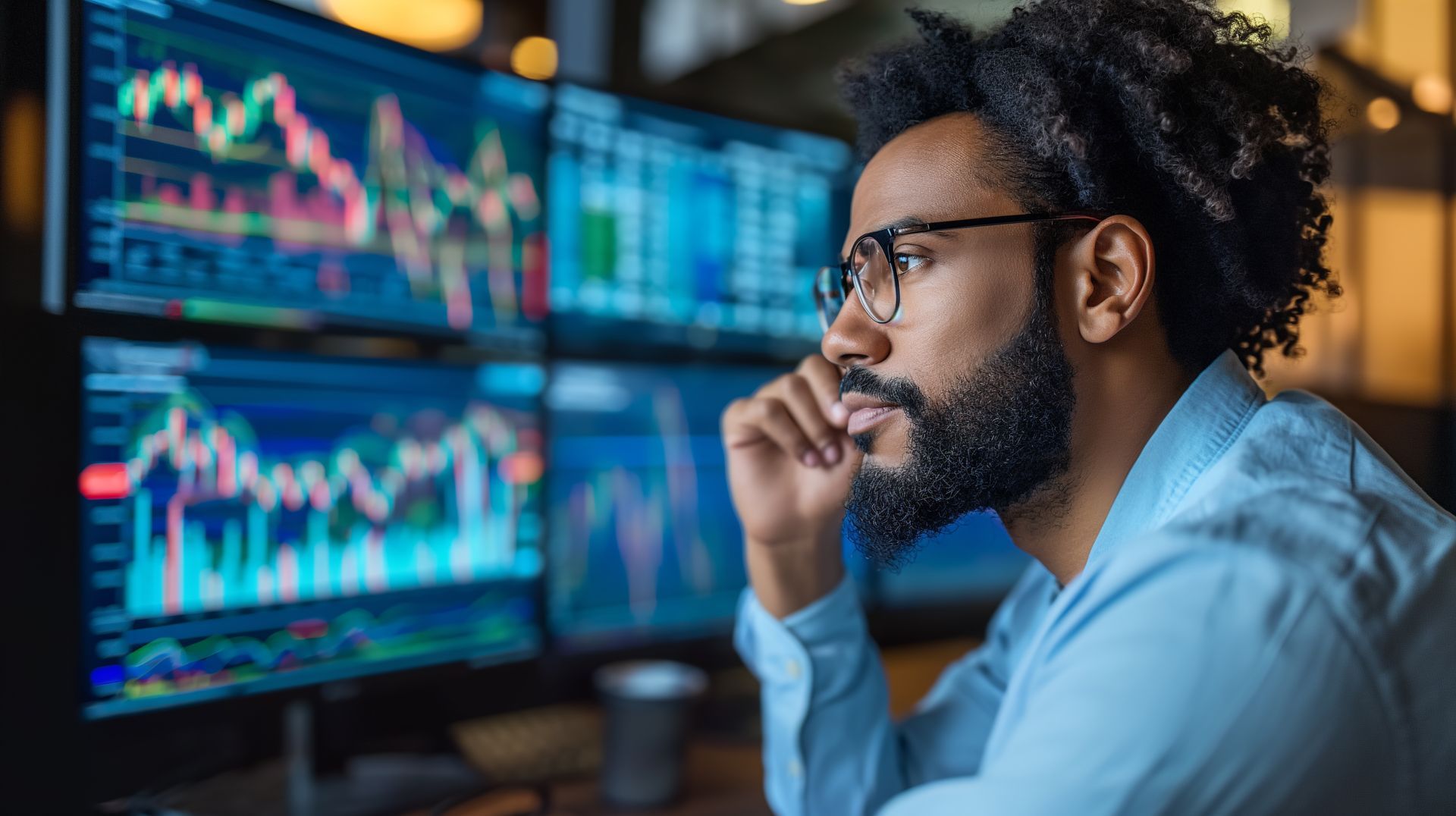 A man with a beard is looking at a computer screen.