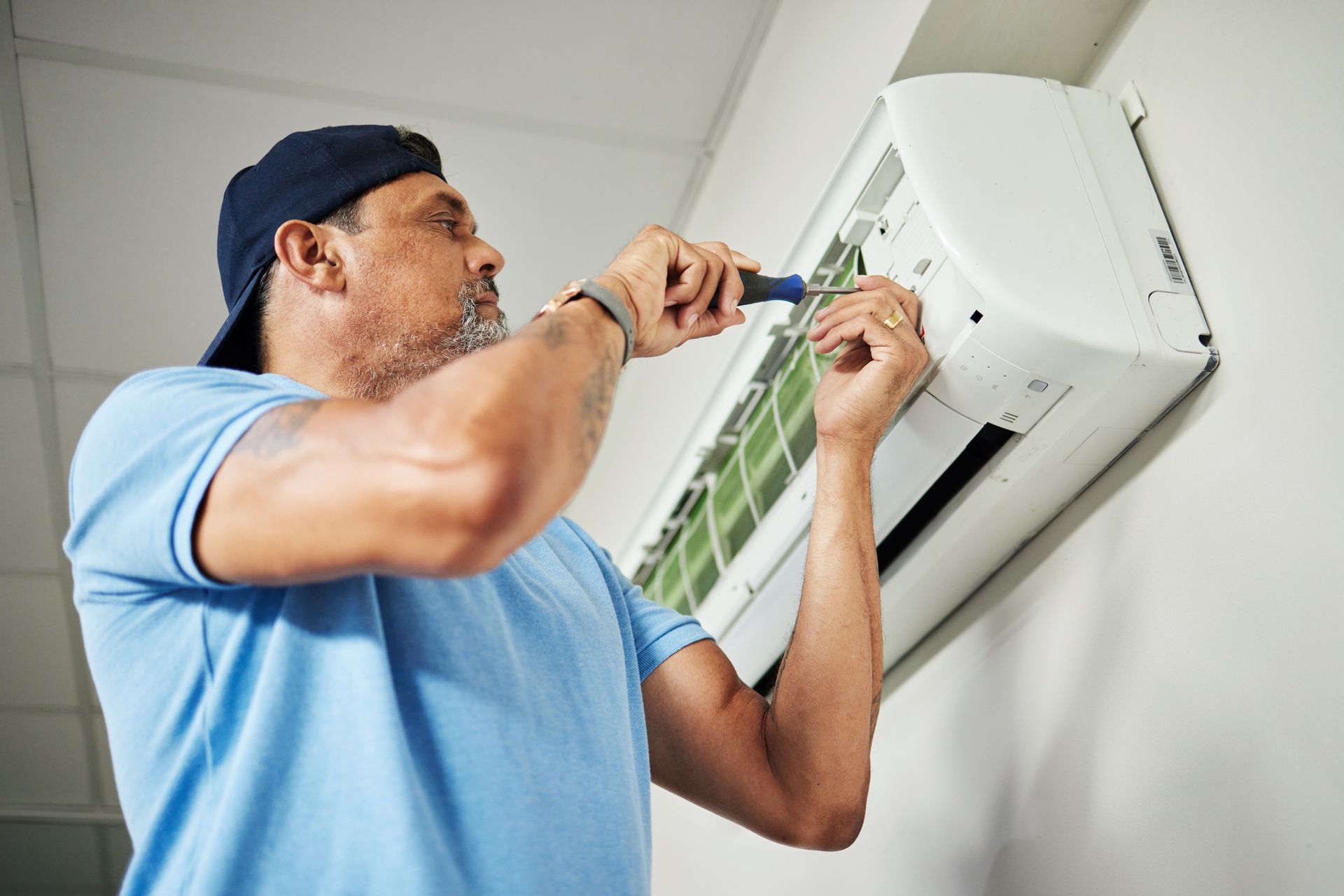A man is working on an AC. A man is working on an AC.