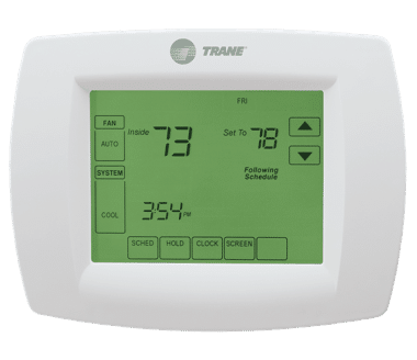 White Trane thermostat with a green backlit White Trane thermostat with a green backlit