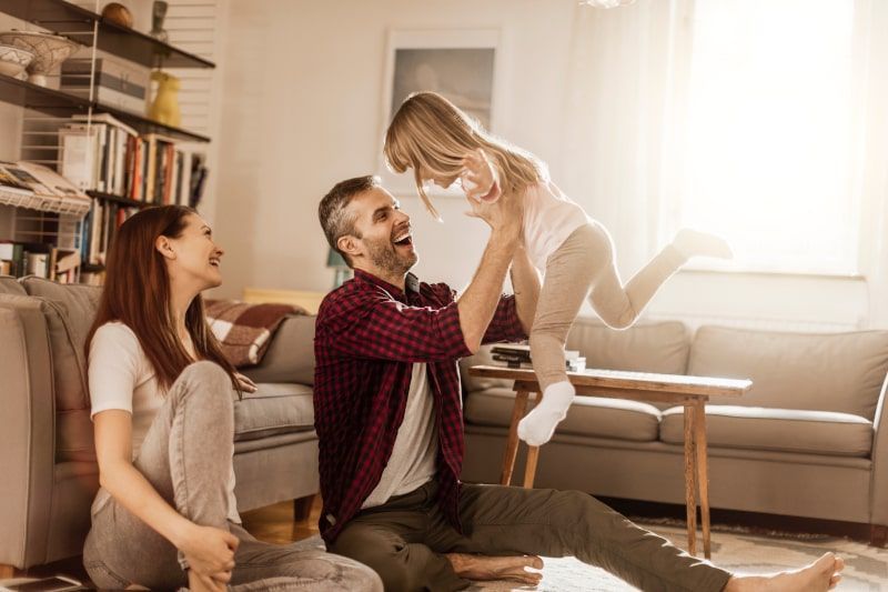 Family playing together in a living room Family playing together in a living room