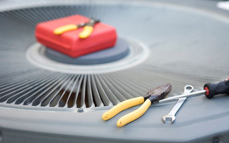 Air conditioner unit with pliers, wrench, and toolbox