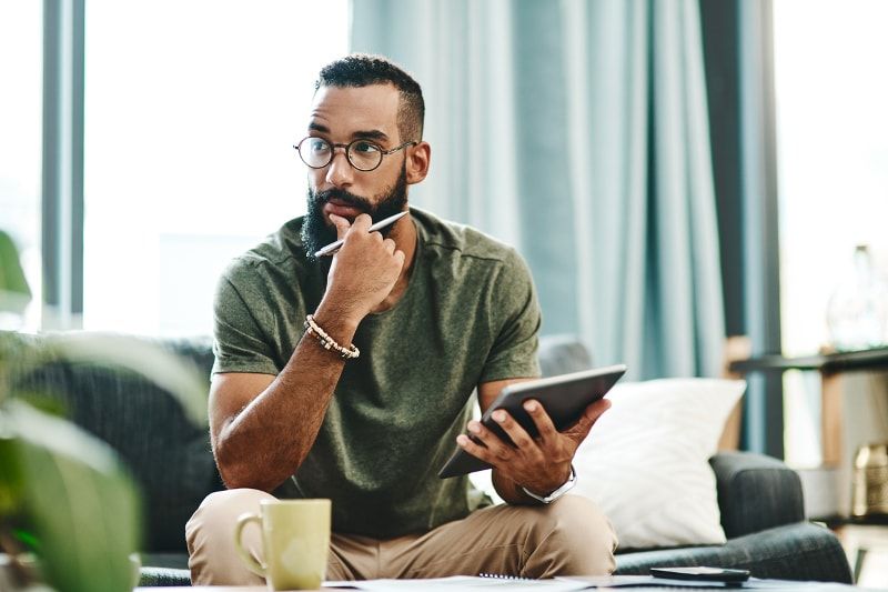 Man with glasses holding tablet and pen Man with glasses holding tablet and pen