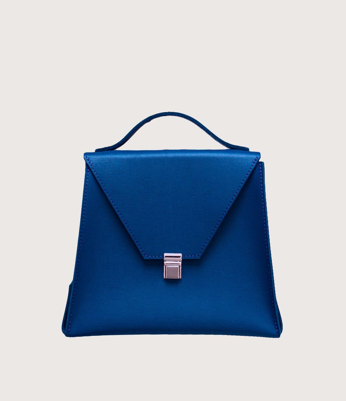 A blue purse with a handle on a white background