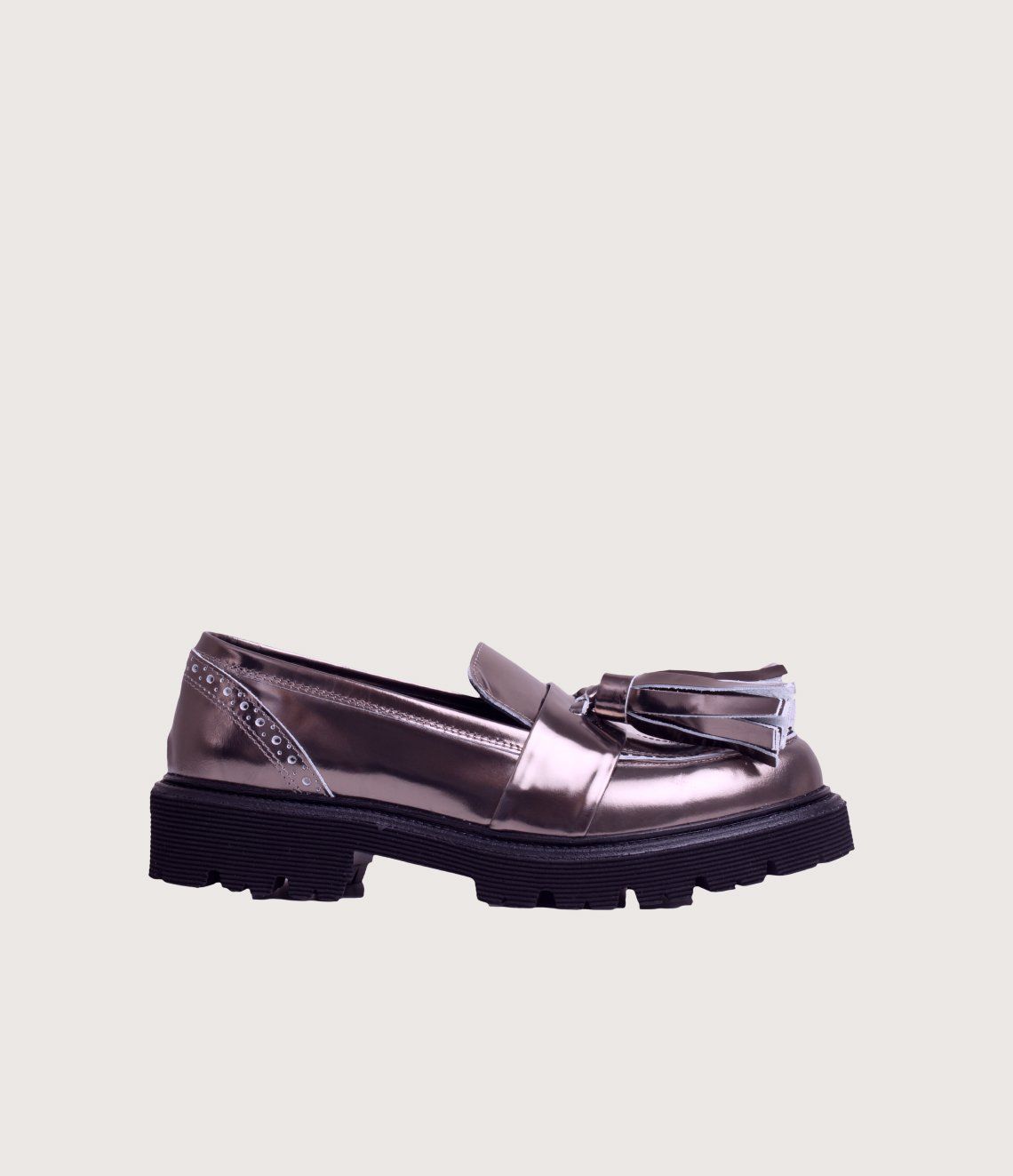A pair of metallic loafers with tassels on a white background.