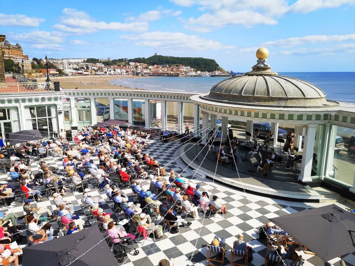 Scarborough Spa Orchestra performing on the outdoor Sun Court stage overlooking Scarborough’s South Bay.
