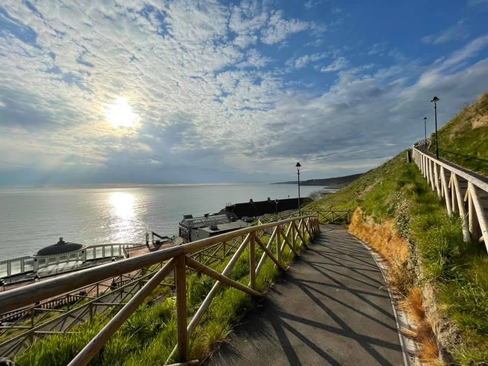 Clifftop path leading down towards Scarborough Spa with views across the sea.