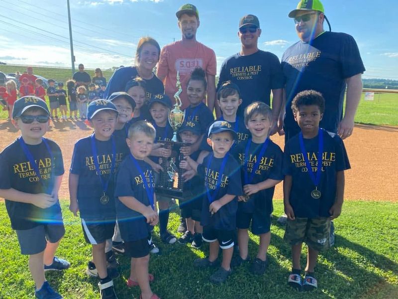 Youth baseball players celebrating on the field