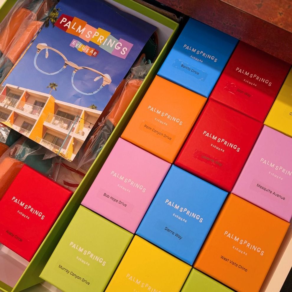 Colorful Palm Springs brochures and gift boxes arranged in a bright display.