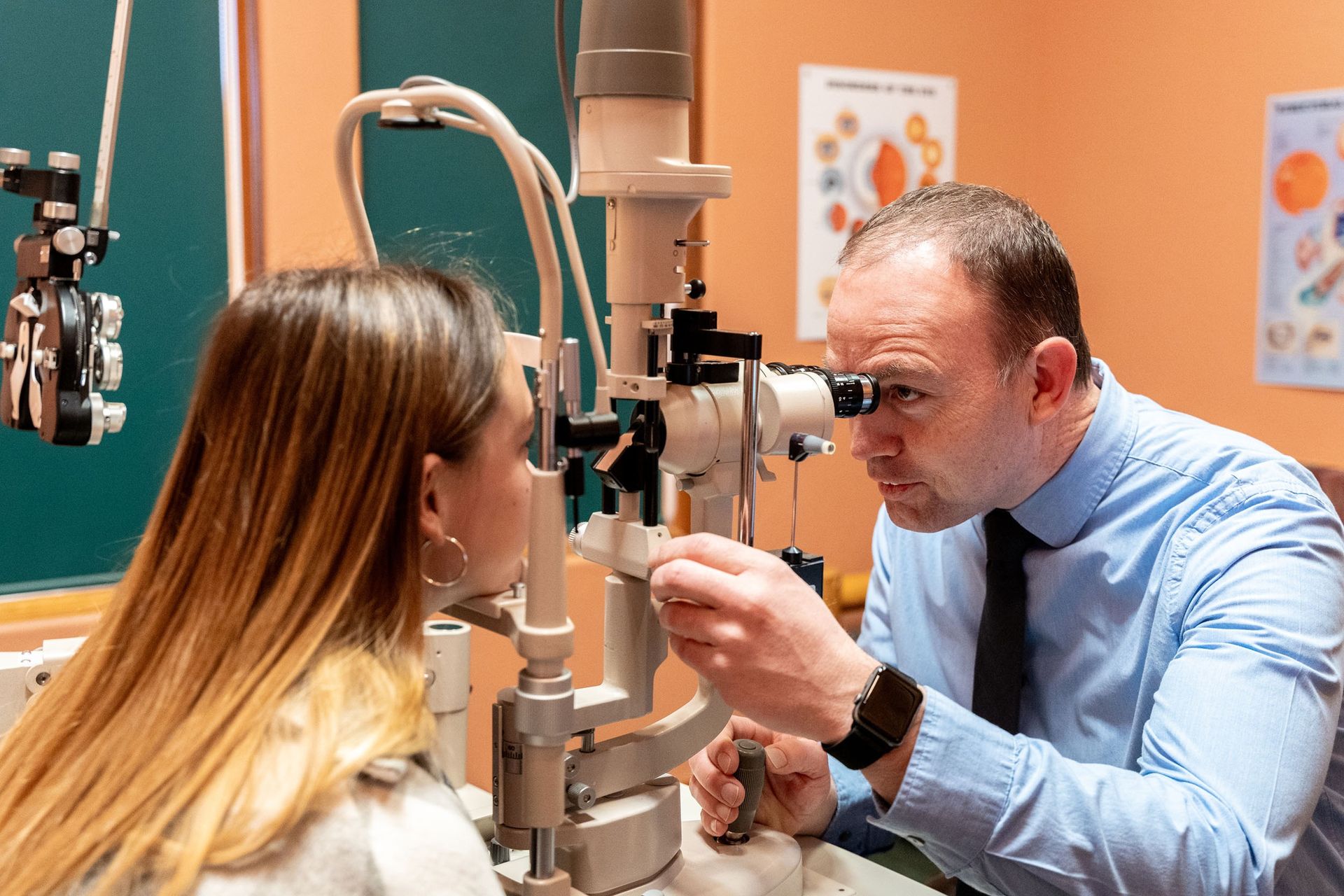 Doctor examining a patient’s eyes with a slit-lamp in an eye clinic