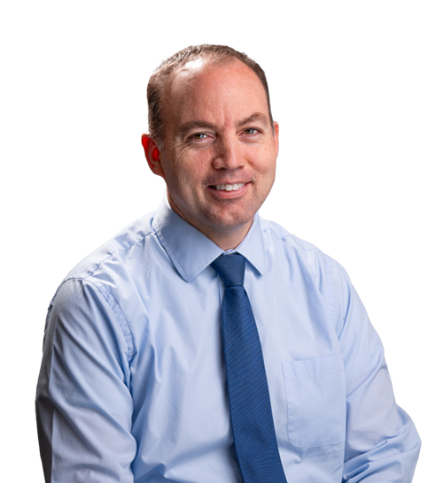 Portrait of a smiling man in a light blue shirt and blue tie against a white background