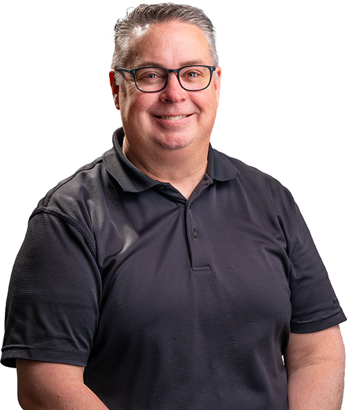 Smiling man in glasses wearing a dark polo shirt against a white background