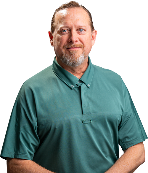 Man in a teal polo shirt posing against a plain white background.