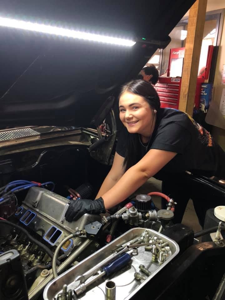 A Woman Is Working on The Engine of A Car — Steve Purse Automotive In Huskisson, NSW